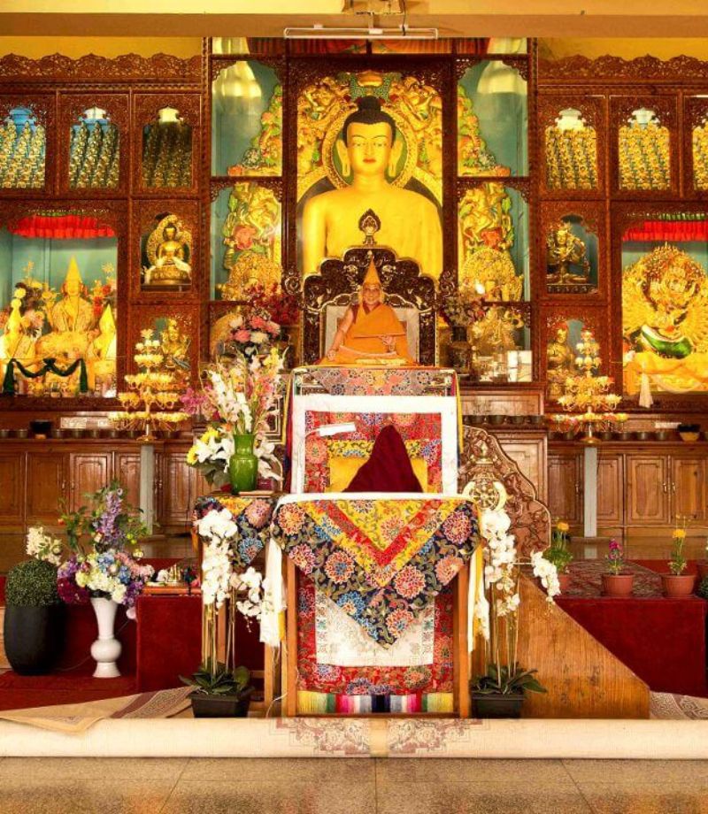 Shrine room decorated with traditional Tibetan Buddhist art and tapestries.